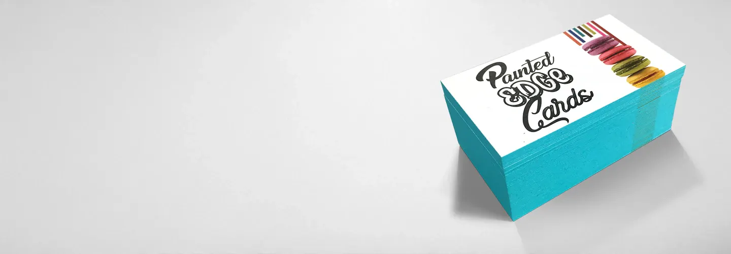 A stack of premium business cards with bright turquoise painted edges