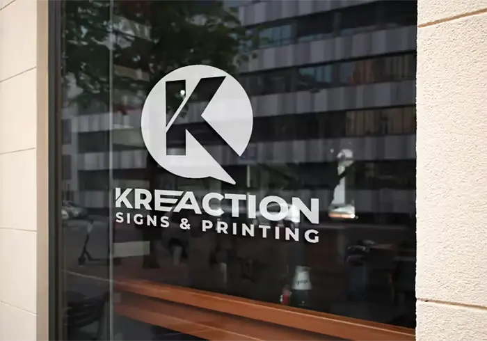 Frosted Kreaction logo decal applied to a storefront window
